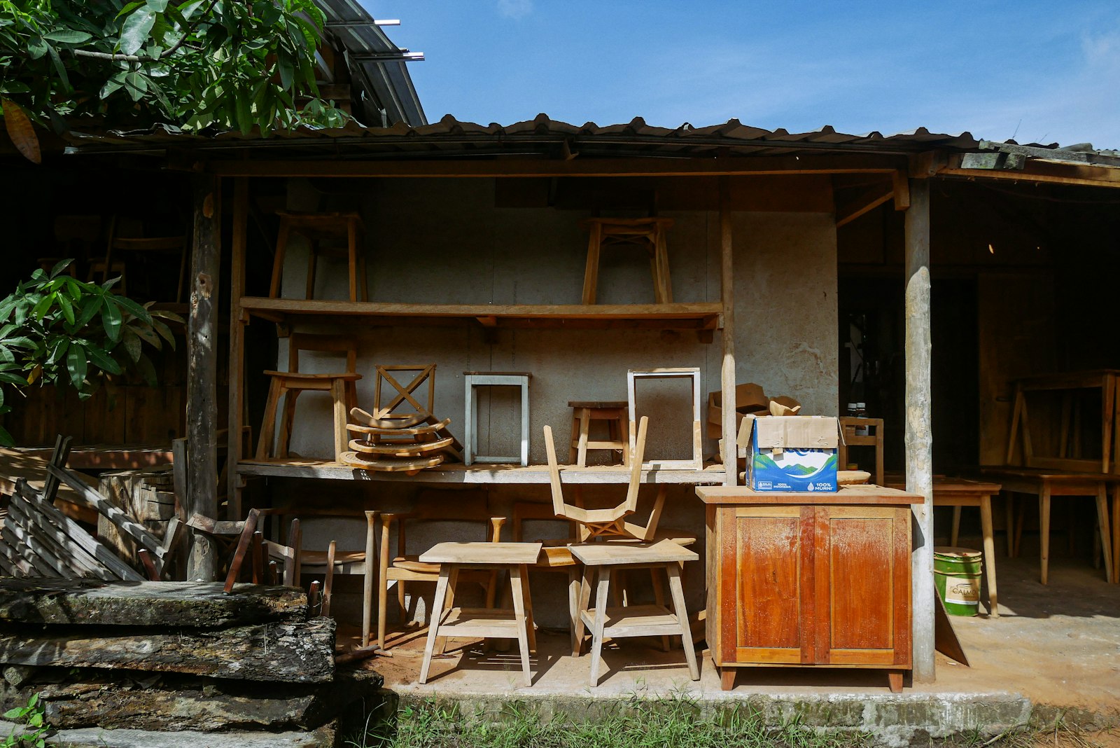 A wooden table and chairs in front of a building