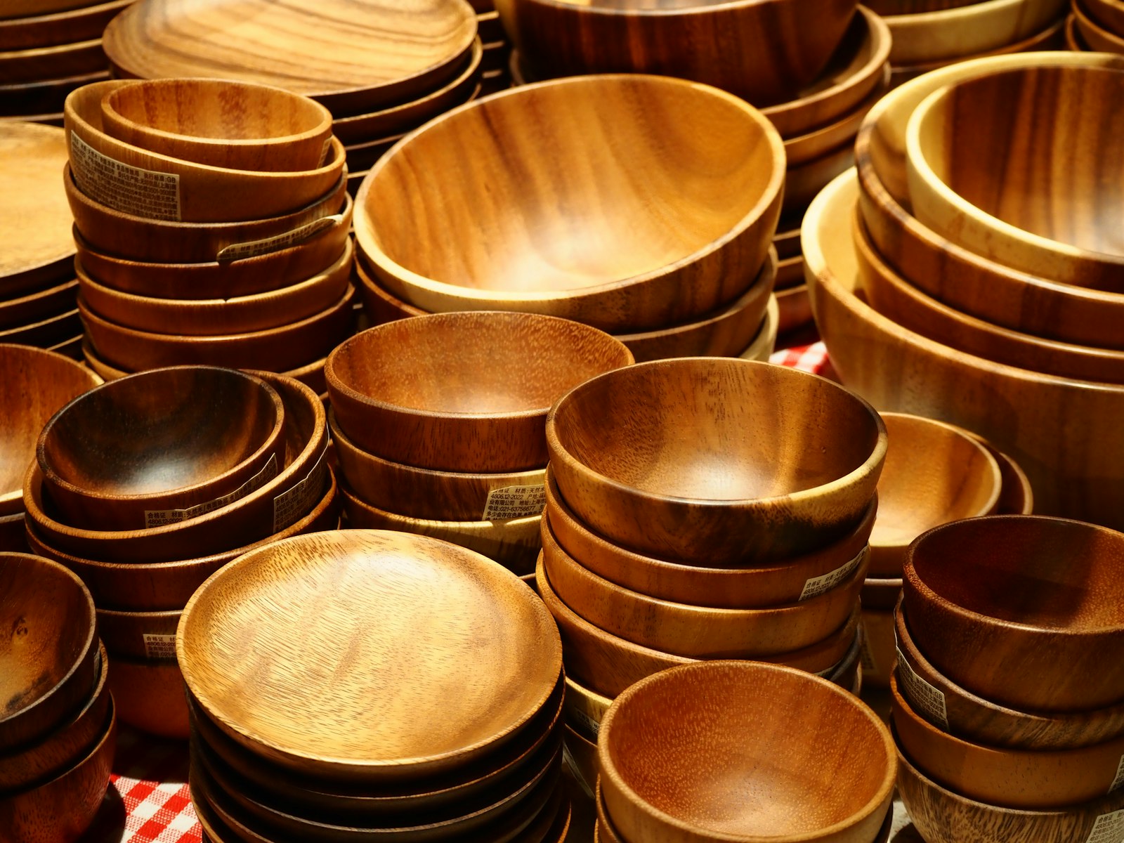 Many wooden bowls and plates are stacked together.