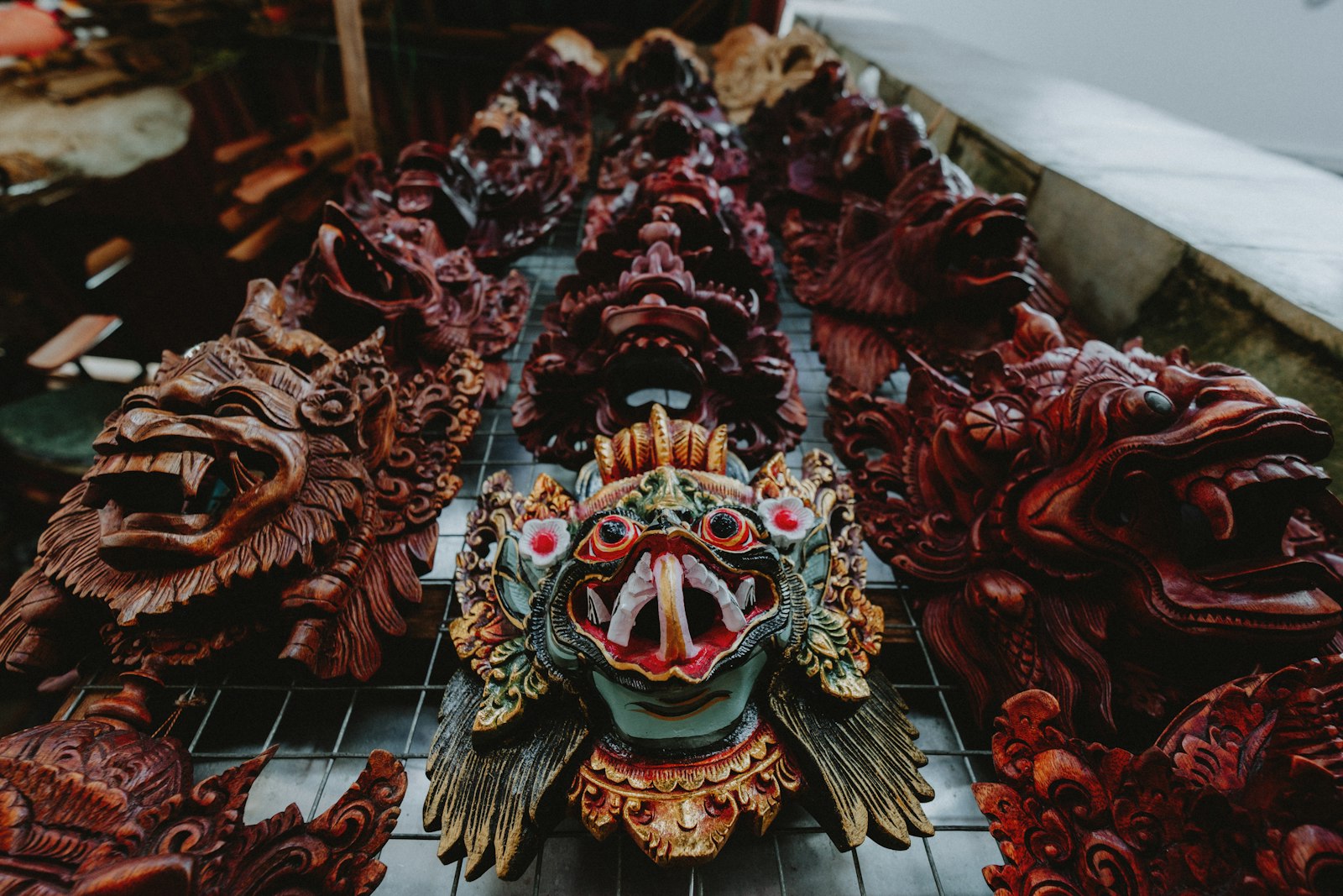 Collection of carved wooden masks with intricate details.